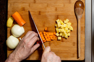 Fresh Vegetables cutting on a wooden board to make Vegetable Broth