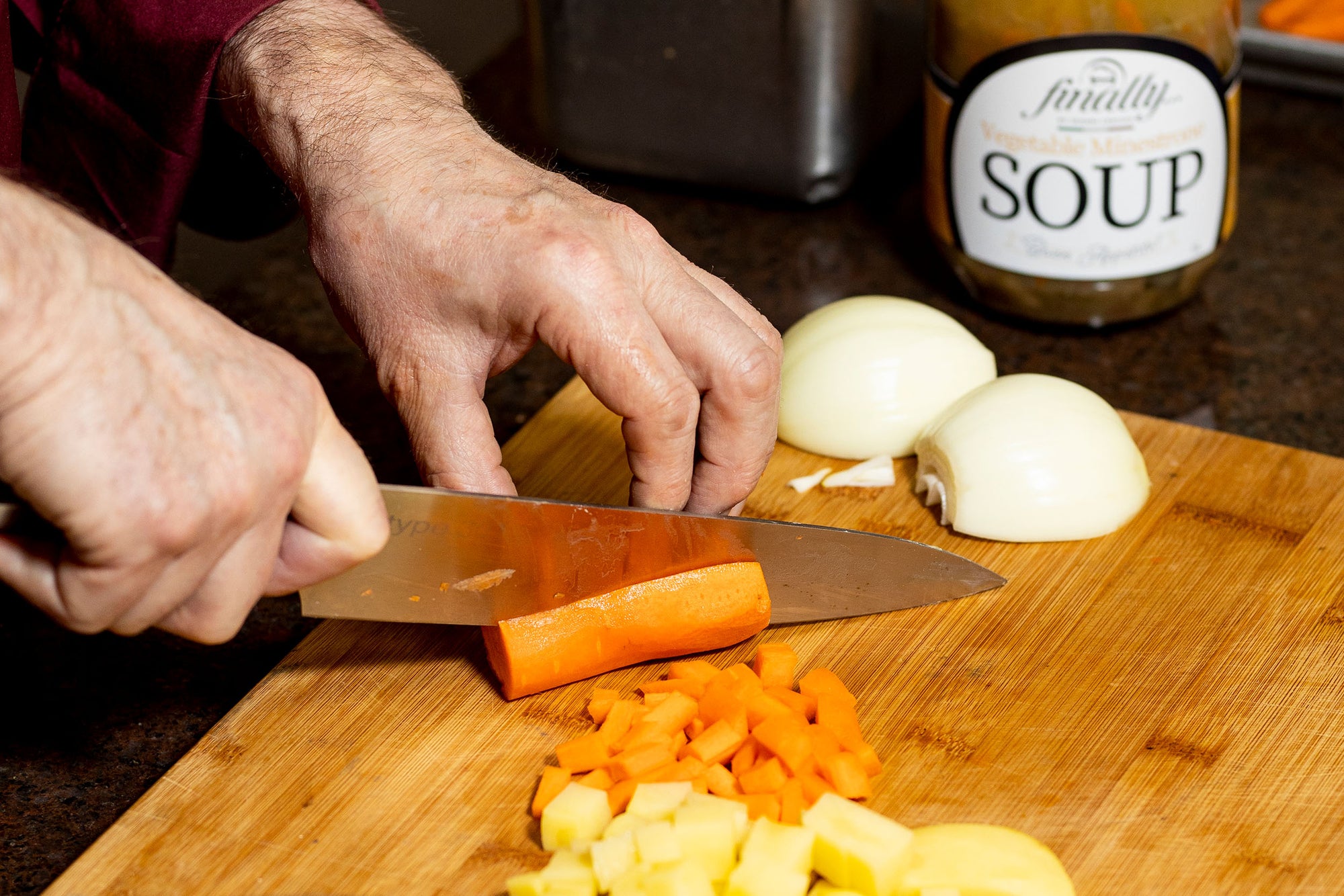 Cutting vegetables on a wooden board to make Vegetable Minestrone Soup