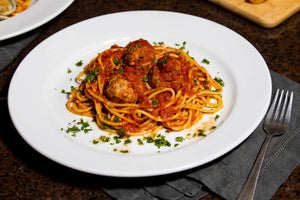 Meatballs In Tomato Sauce with pasta on a plate