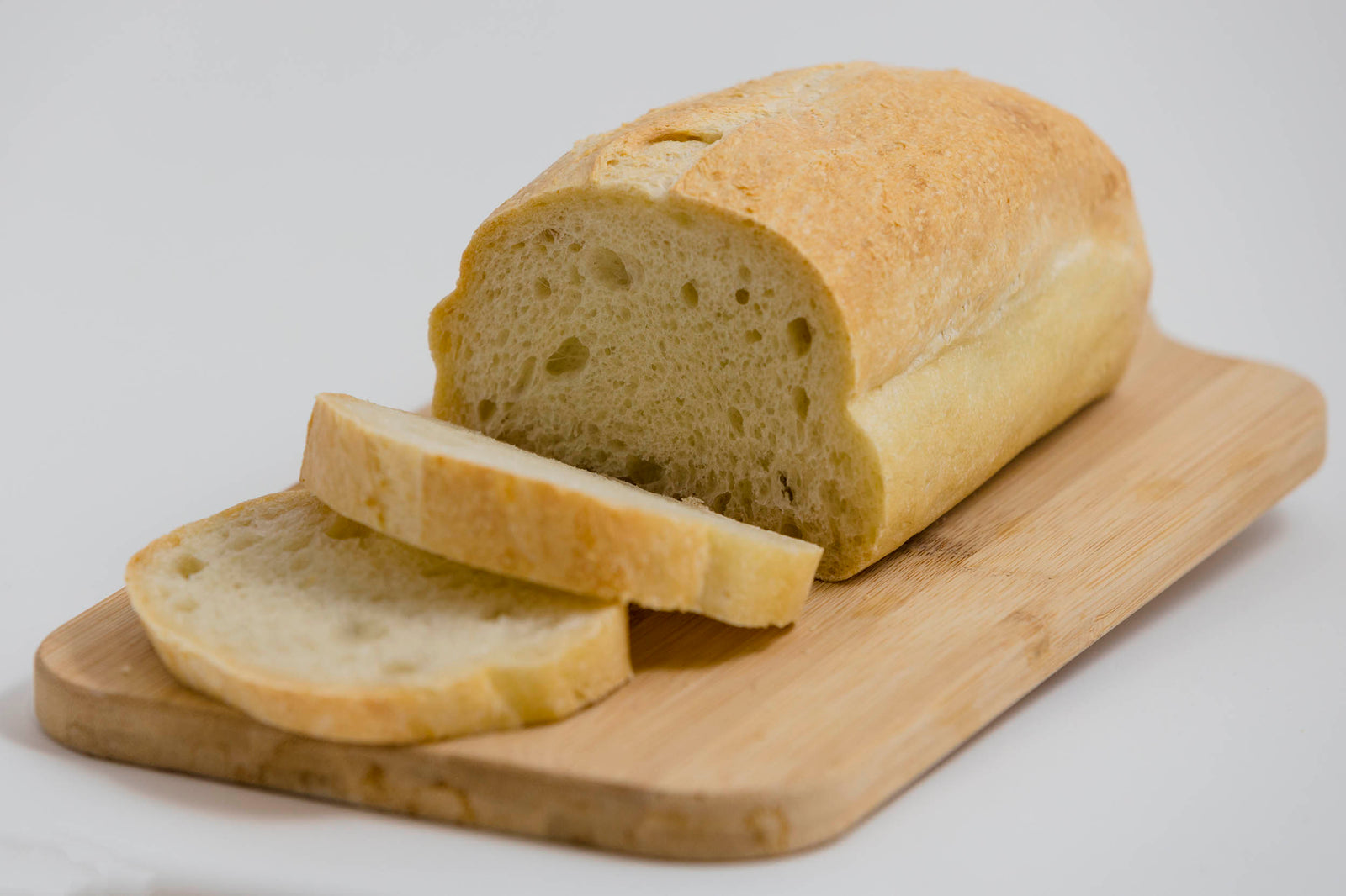 Plain Bread sliced on a wooden board
